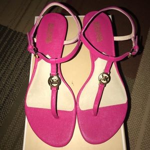 Pink Michael Kors wedge sandals.